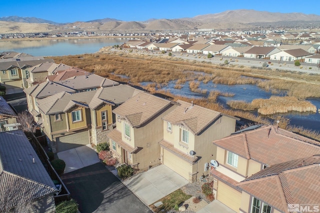 drone / aerial view featuring a water and mountain view