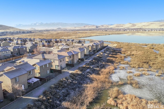 birds eye view of property with a water and mountain view