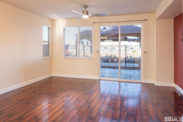 spare room featuring ceiling fan and dark wood-type flooring