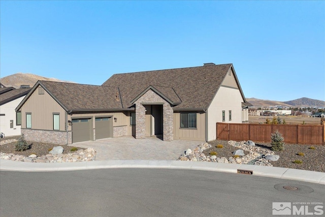 view of front facade featuring a mountain view and a garage