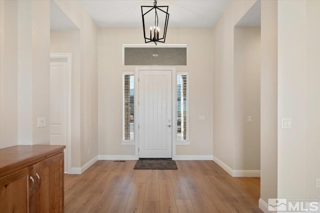 entryway featuring a notable chandelier and light wood-type flooring