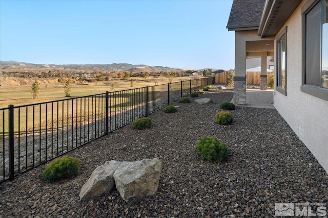 view of yard featuring a mountain view and a rural view