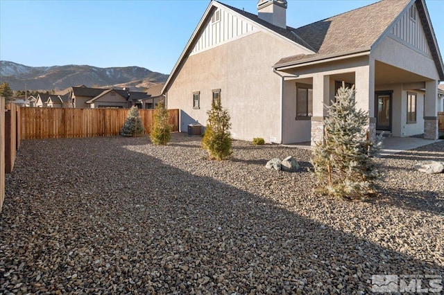 view of home's exterior featuring a mountain view and central air condition unit