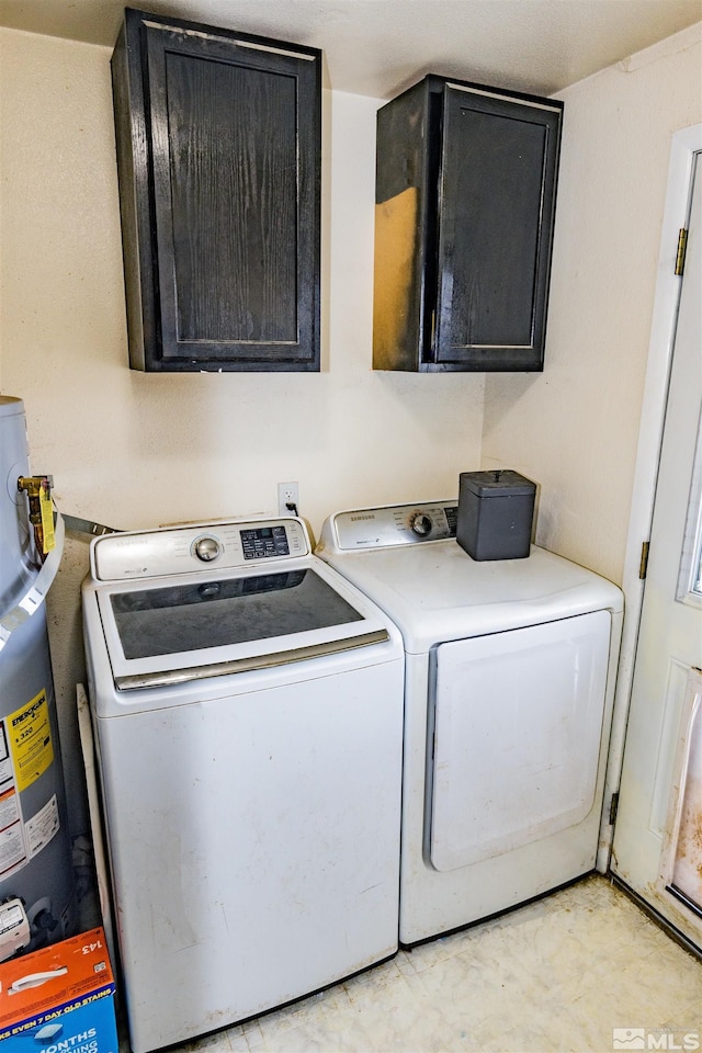 laundry room with cabinet space, water heater, and independent washer and dryer