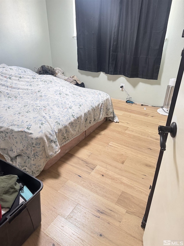 bedroom with wood finished floors