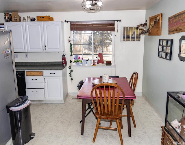 dining room with light floors and baseboards