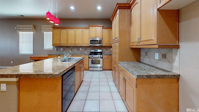 kitchen featuring a kitchen island with sink, sink, light tile patterned floors, appliances with stainless steel finishes, and tasteful backsplash