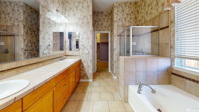 bathroom featuring tile patterned floors, vanity, and shower with separate bathtub