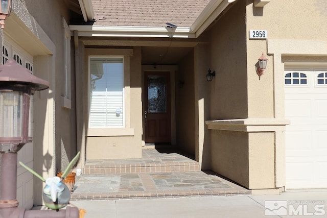 doorway to property featuring a garage