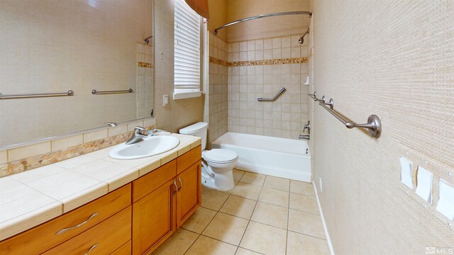 full bathroom with tile patterned flooring, vanity, toilet, and tiled shower / bath