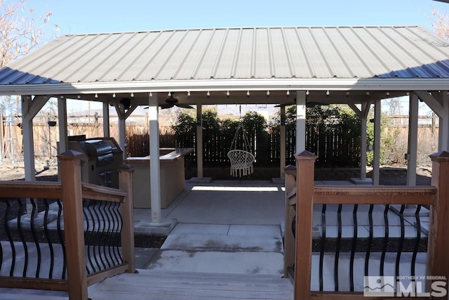 view of patio / terrace with a gazebo, area for grilling, and ceiling fan