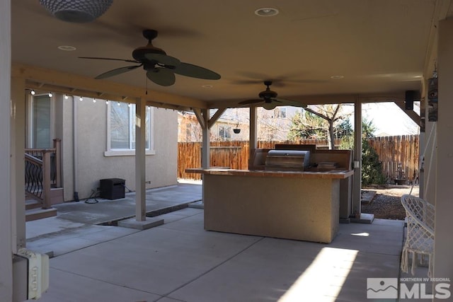 view of patio / terrace with an outdoor bar, area for grilling, and ceiling fan