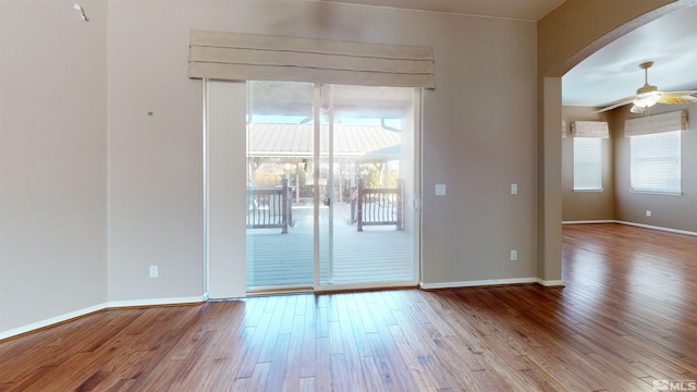 empty room with ceiling fan and light hardwood / wood-style floors