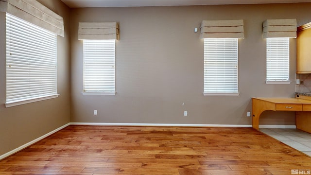 spare room featuring light wood-type flooring