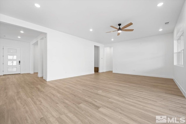 spare room with ceiling fan and light hardwood / wood-style floors