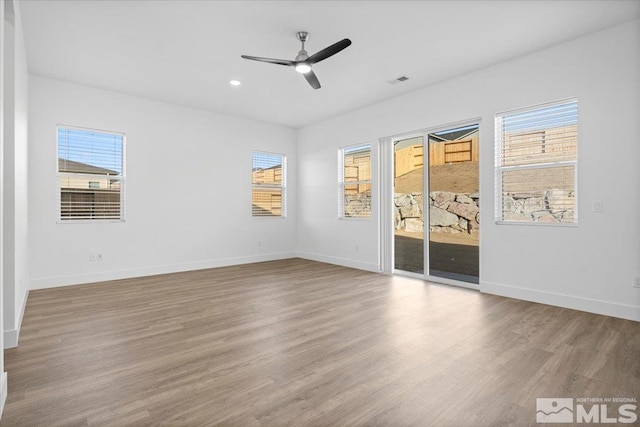 empty room featuring light hardwood / wood-style flooring and ceiling fan