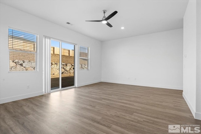 empty room featuring hardwood / wood-style floors and ceiling fan