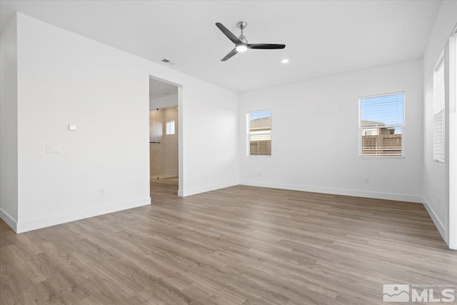 spare room featuring ceiling fan and light hardwood / wood-style floors