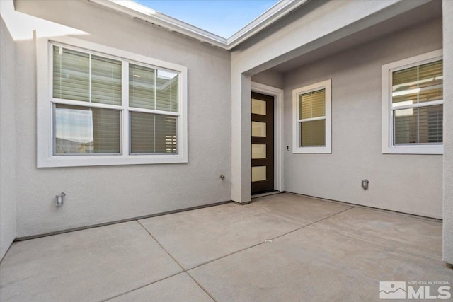 entrance to property featuring a patio area