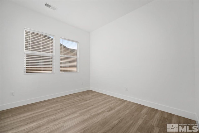 unfurnished room with light hardwood / wood-style floors