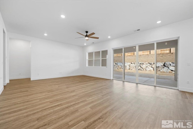 unfurnished living room with ceiling fan and light hardwood / wood-style floors