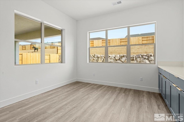 unfurnished room with light wood-type flooring