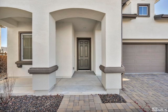 view of exterior entry with a garage