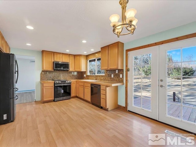 kitchen with french doors, black appliances, pendant lighting, light hardwood / wood-style flooring, and a notable chandelier