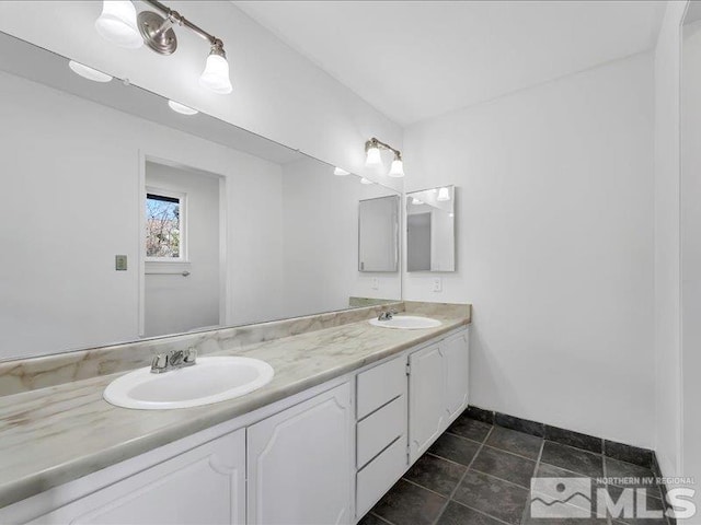 bathroom with tile patterned flooring and vanity