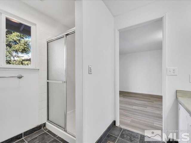 bathroom with vanity, an enclosed shower, and wood-type flooring