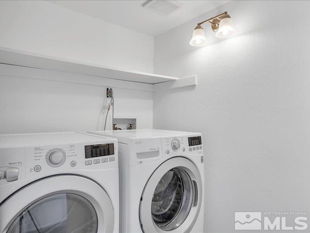 laundry room with washing machine and dryer