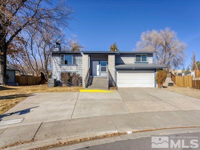 view of front of home featuring a garage and central air condition unit