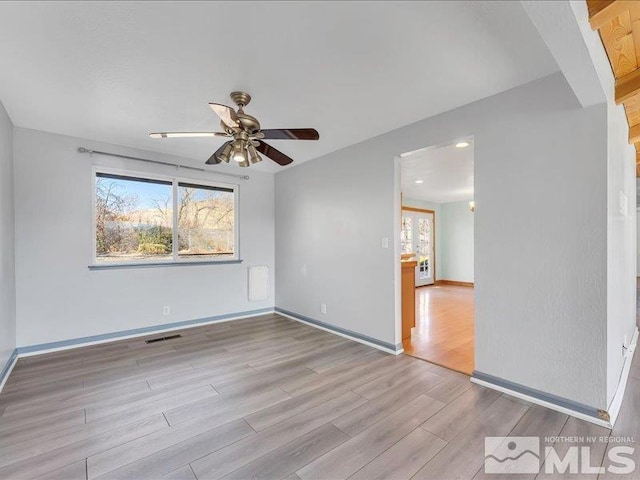 empty room featuring ceiling fan and light hardwood / wood-style flooring