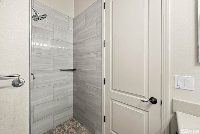 bathroom with tiled shower