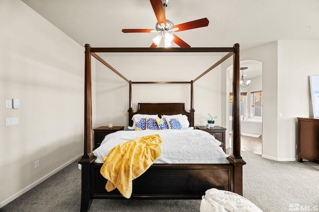 bedroom featuring carpet, ceiling fan with notable chandelier, and ensuite bath