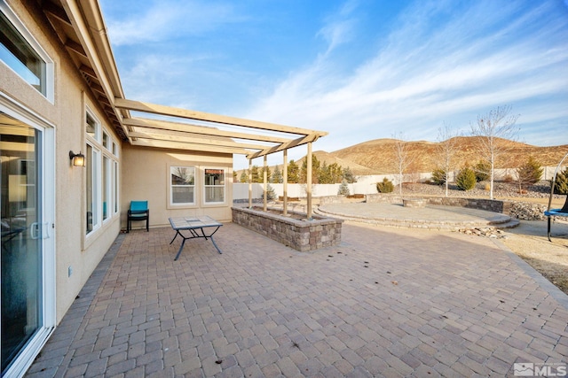 view of patio with a mountain view and a pergola