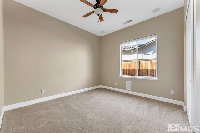 carpeted spare room with ceiling fan