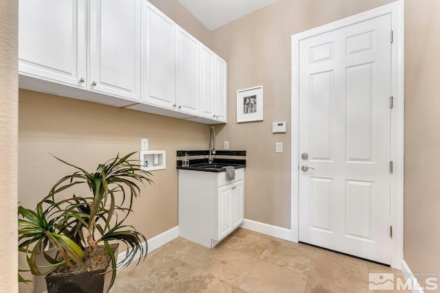 laundry area featuring cabinets, washer hookup, and sink