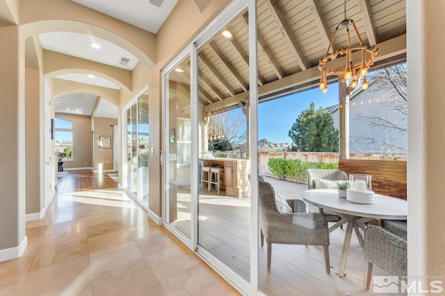 entryway with lofted ceiling with beams, light hardwood / wood-style floors, and wood ceiling