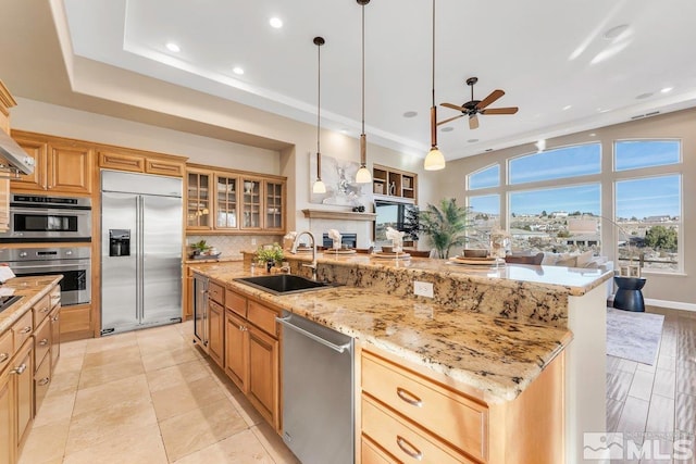 kitchen with decorative backsplash, stainless steel appliances, sink, pendant lighting, and a large island