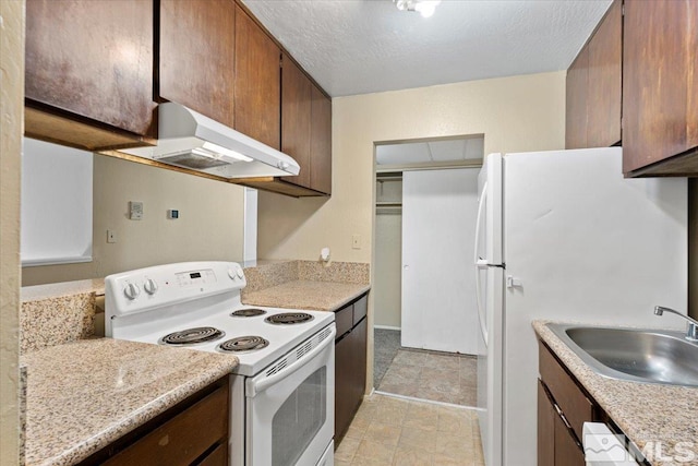 kitchen featuring a textured ceiling, sink, exhaust hood, and white appliances