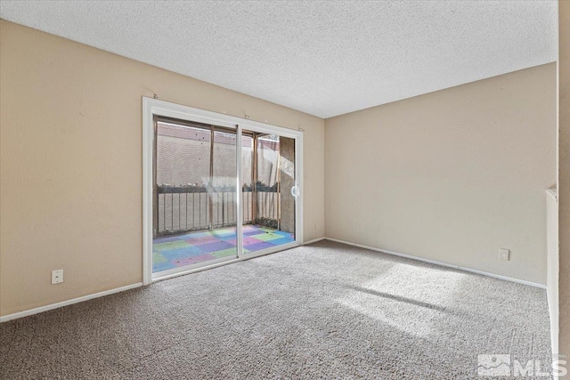 unfurnished room with carpet and a textured ceiling