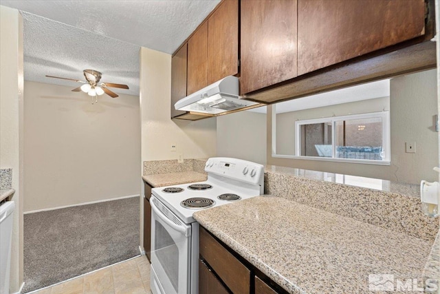 kitchen featuring a textured ceiling, white appliances, ventilation hood, ceiling fan, and light colored carpet