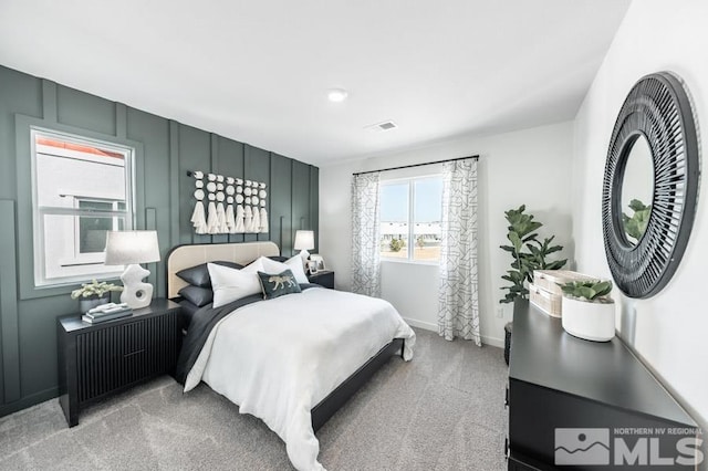 bedroom featuring light colored carpet