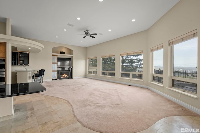 living room with ceiling fan and light colored carpet