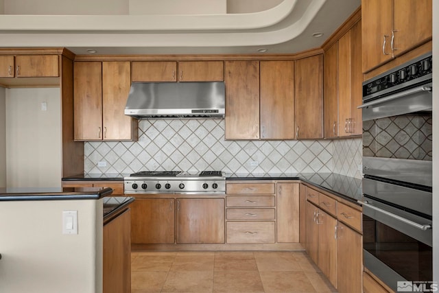 kitchen featuring decorative backsplash, ventilation hood, stainless steel appliances, and light tile patterned flooring