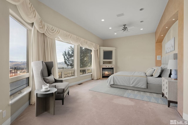 bedroom with multiple windows and light carpet