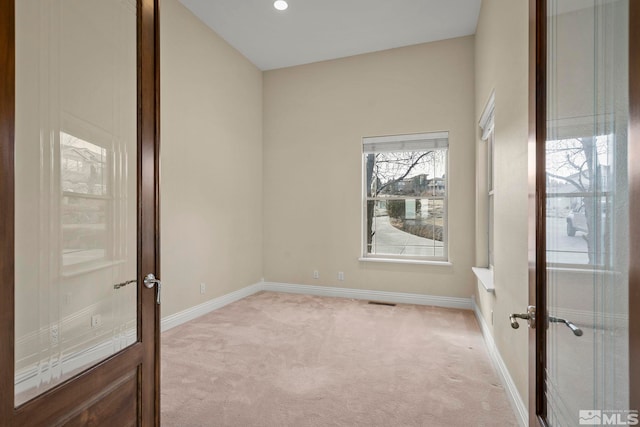 carpeted spare room with french doors