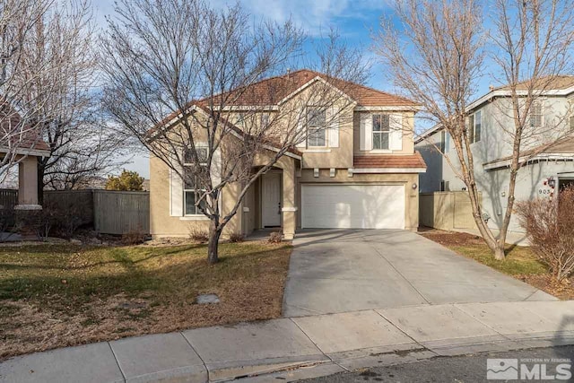 view of property featuring a garage and a front lawn