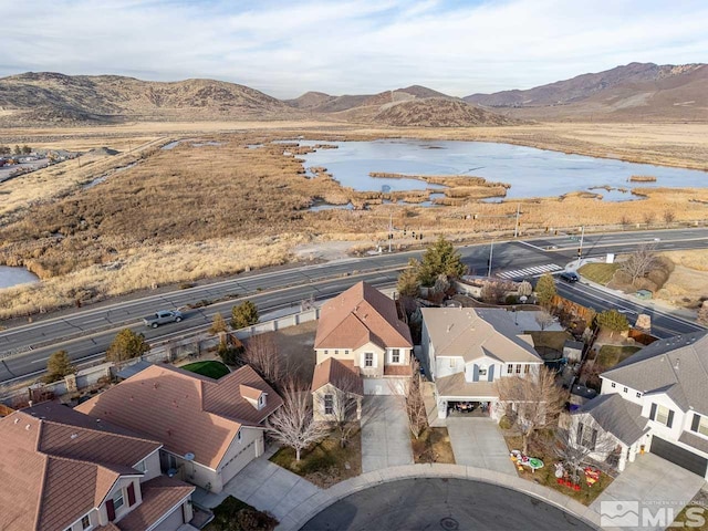 drone / aerial view with a water and mountain view